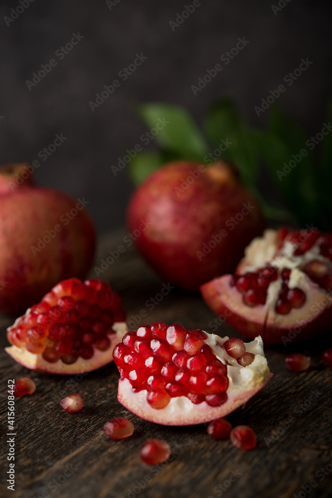 Fresh ripe pomegranate on a wooden background Fresh ripe pomegranate on a wooden background