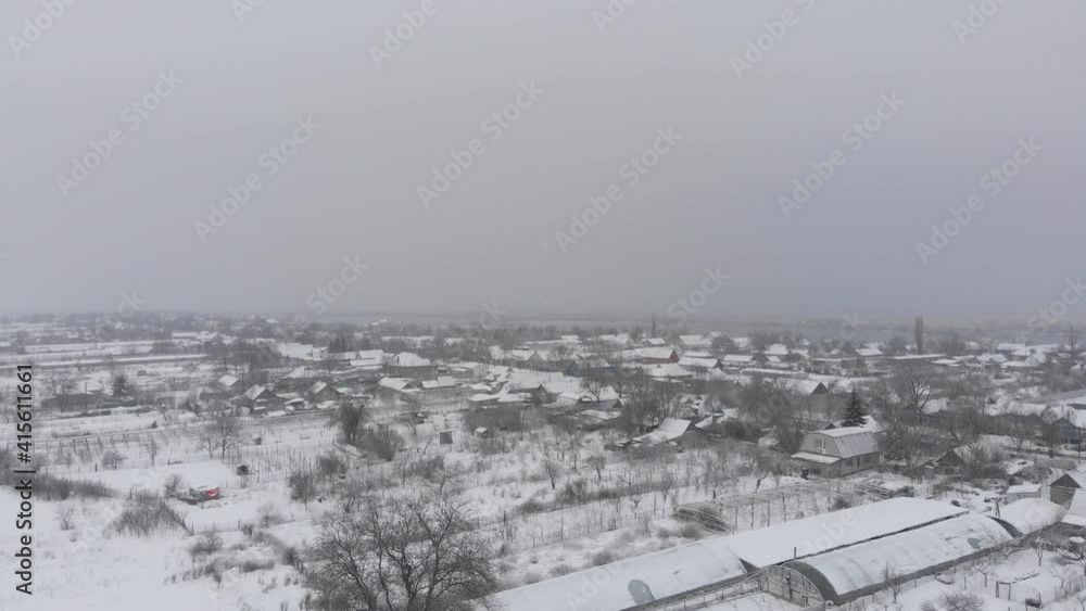 Snow-covered village in Eastern Europe. View from above Snow-covered village in Eastern Europe. View from above