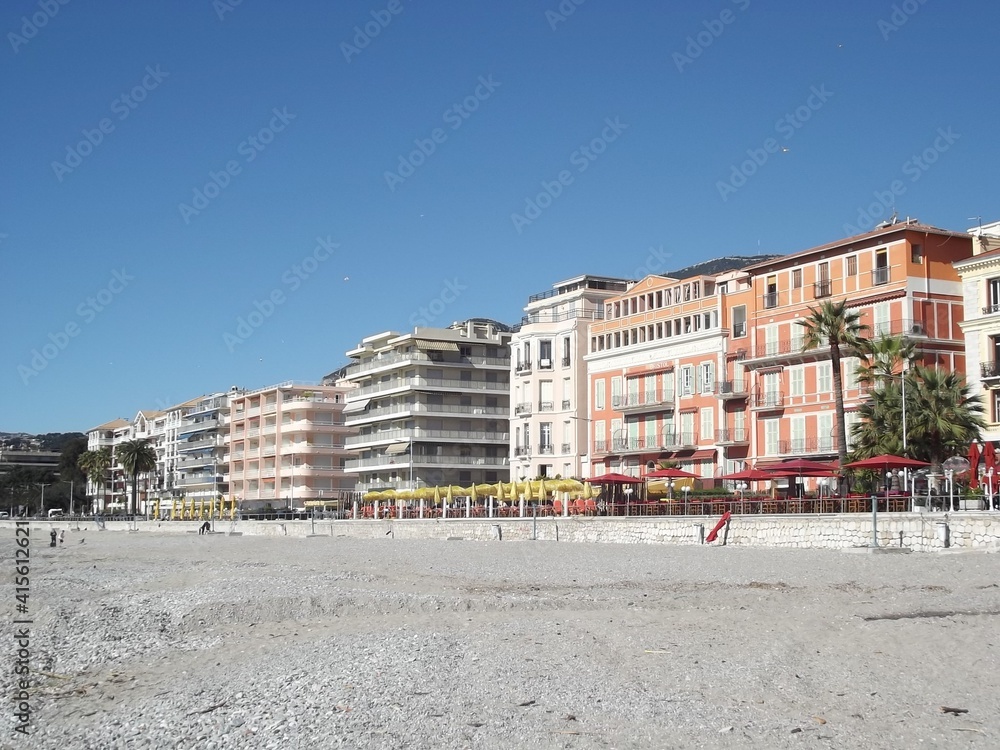 pebble beach and cafes on the promenade du soleil of Menton, France
