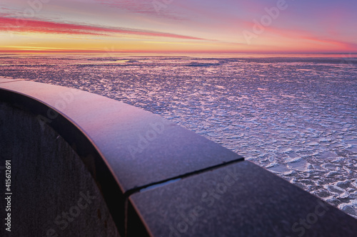 Ice sculpture mooring post during sunset in winter at the Afsluitdijk in The Netherlands © fotografiecor