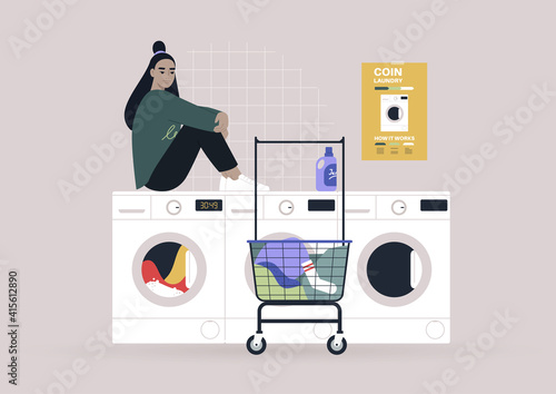 Household chores concept, a young female Asian character waiting for their laundry in a coin laundromat