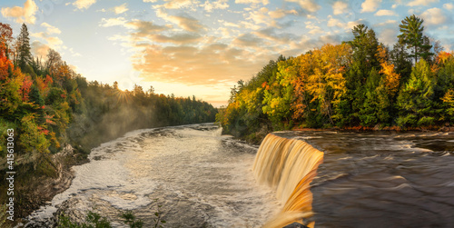 Beautiful sunrise shining on the Upper Tahquamenon Falls in Autumn - Michigan State Park in the Upper Peninsula - waterfall