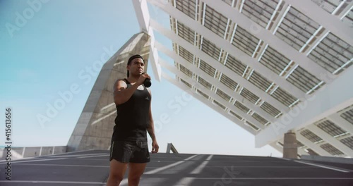 Young Fit Athlete Exhausted Taking Break and Drinking Water After Workout Exercising Outdoor in City Background. Exercising Strength, Cardio and Power. Sport Healthy Lifestyle Concept