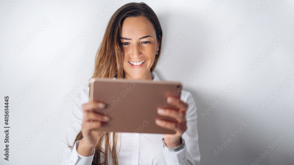 Satisfied lovely woman holds modern cell phone, texts with friend online in chat, dressed in stylish clothes Satisfied lovely woman holds modern cell phone, texts with friend online in chat, dressed in stylish clothes