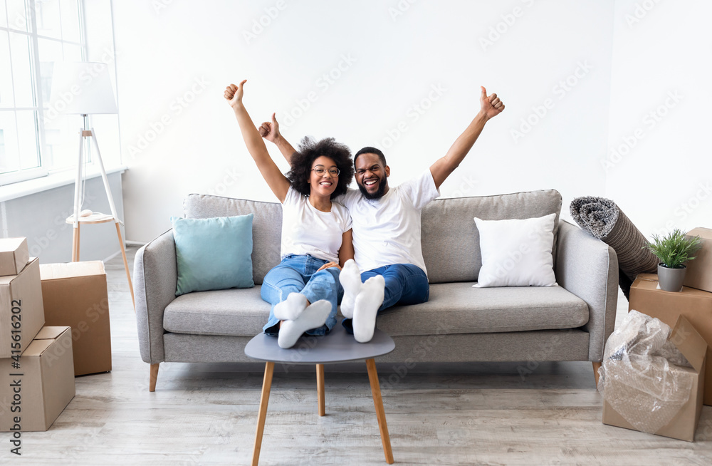 Black Spouses Celebrating Moving Day In New House, Gesturing Thumbs-Up Black Spouses Celebrating Moving Day In New House, Gesturing Thumbs-Up