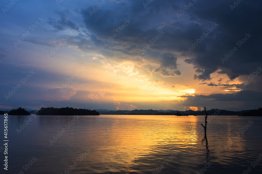 Fototapeta premium Rays of sunset at reservoir, Kanchanaburi