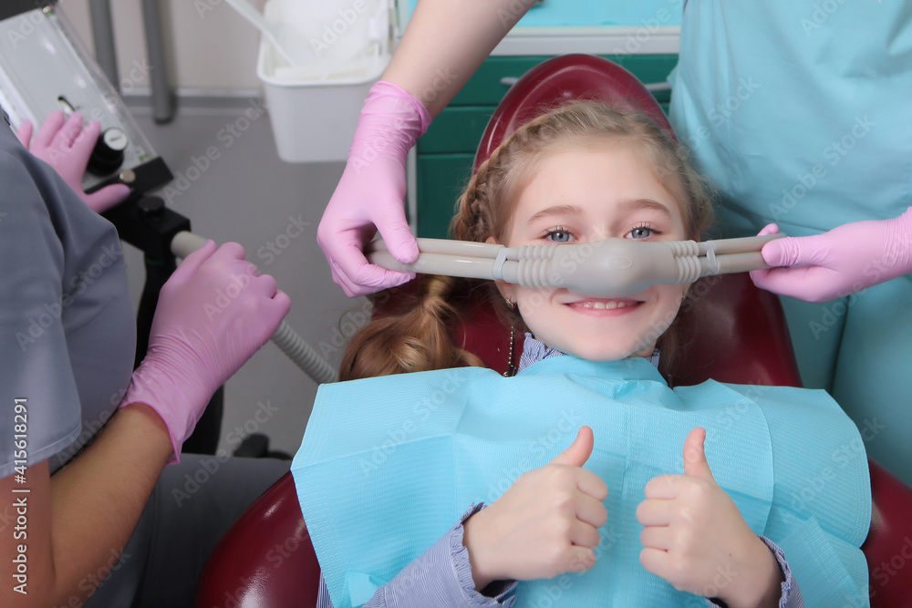 A little girl is comfortable to treat her teeth under superficial