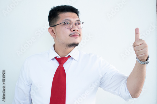 Portrait of a handsome Asian man wearing glasses. Wear a white shirt and red tie.