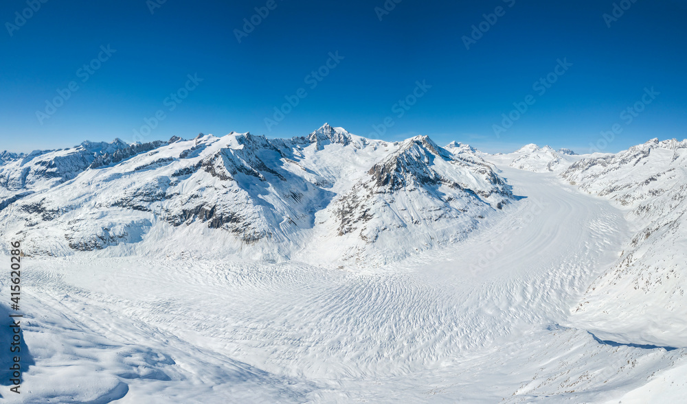 Aerial panorama of Great Aletsch Glacier in Alps winter season, covered with deep snow, Switzerland, which is a unesco heritage (stitched large file)
