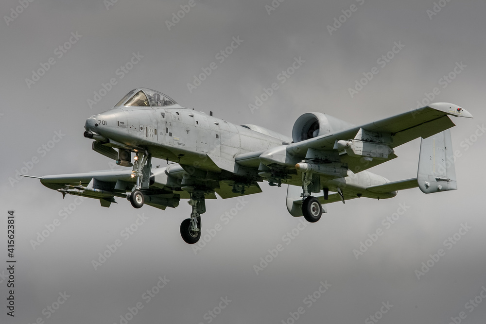 A10 tank buster jet in grey colour scheme landing on a stormy day with dark clouds