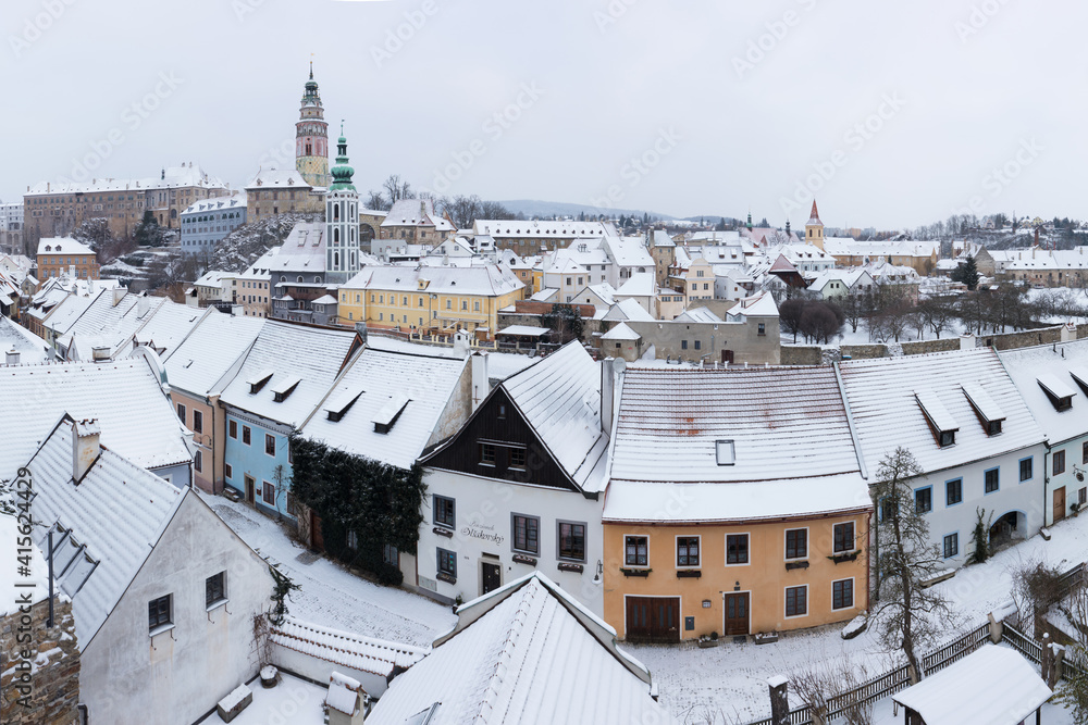 Obraz premium Panoramic view of Cesky Krumlov in winter season, Czech Republic. View of the snow-covered roofs. Travel and Holiday in Europe. Christmas time. Historical houses and streets. UNESCO World Heritage