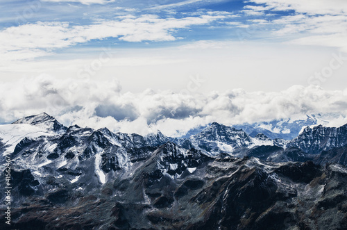 alp mountains with snow and clouds