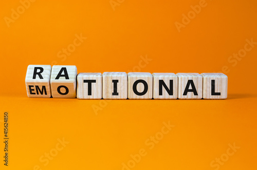 Rational or emotional symbol. Turned wooden cubes and changed the word 'rational' to 'emotional'. Beautiful orange background. Psychological and rational or emotional concept. Copy space. photo