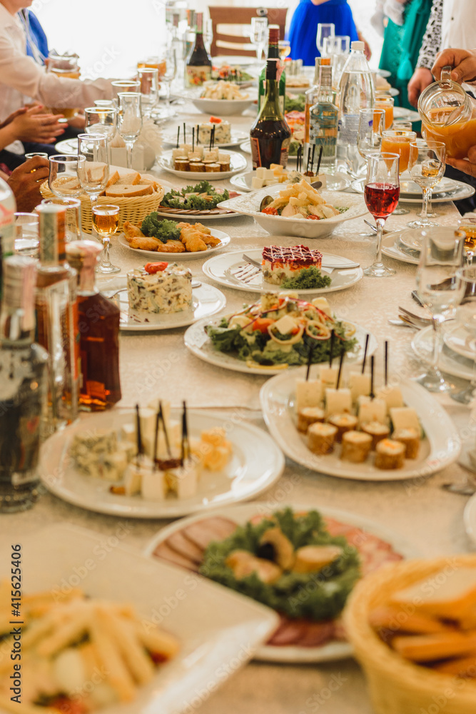 Table setting, food and decorations for important and family events, delicious snacks and hot dishes.