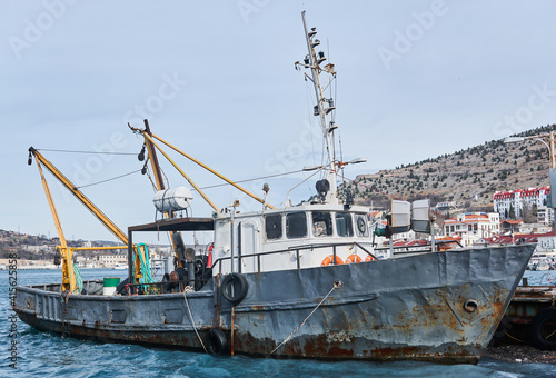 small old fishing ship seiner moored in the harbor