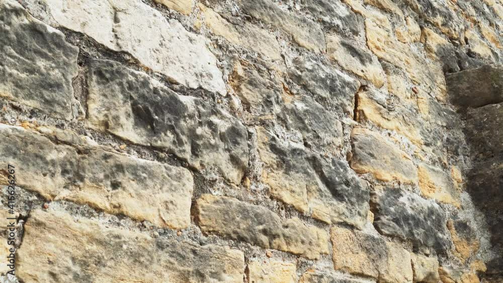Ancient moldy textured stone wall with weathered damaged surface Ancient moldy textured stone wall with weathered damaged surface
