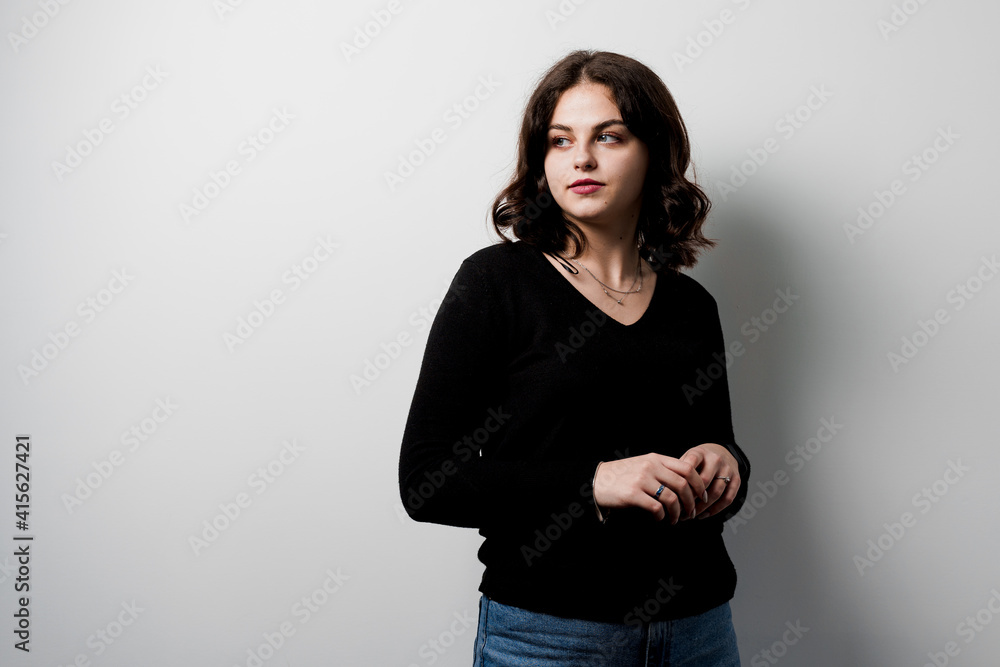 Obraz premium Young woman student on white background. Attractive girl teacher explain rules in english class. Education in university. Foreign school private study with a school girl.