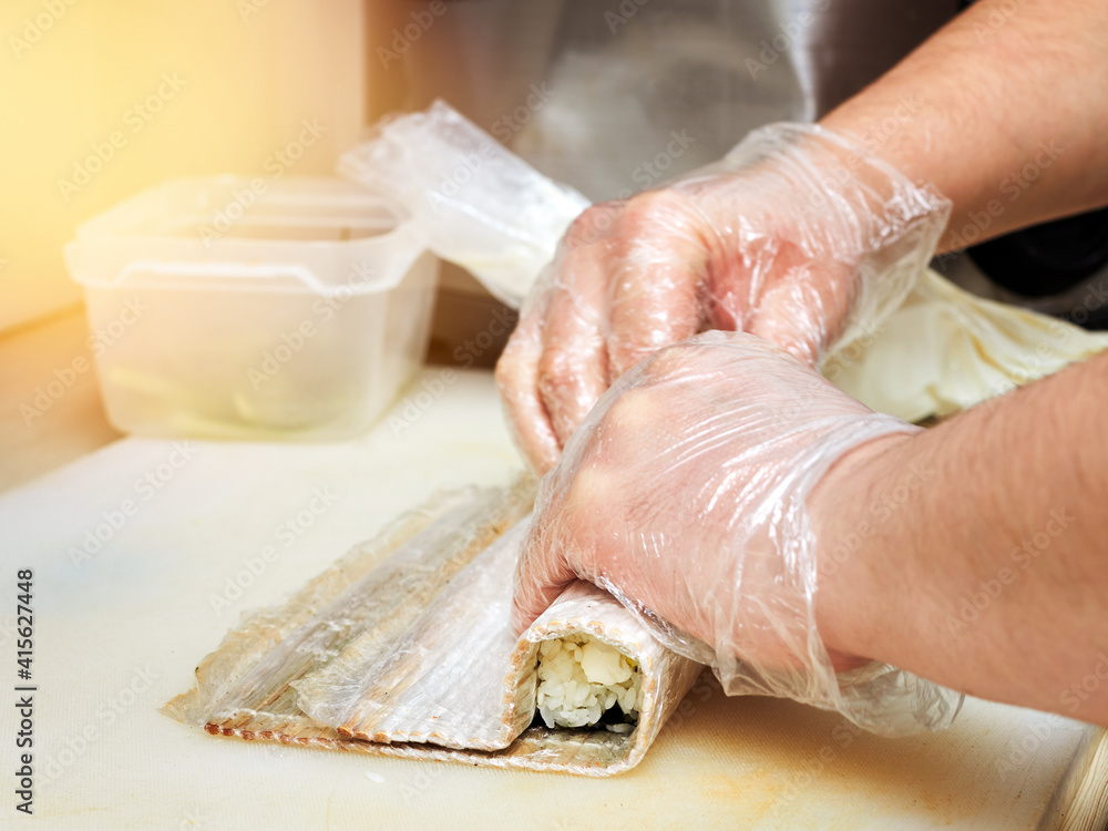 preparing Japanese rolls in the kitchen.