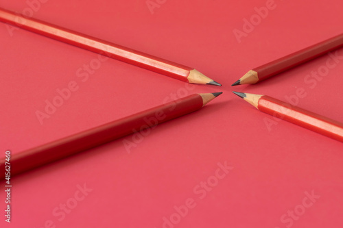 Lápices color rojo con fondo rojo pastel. Grupo, equipo. Conceptual