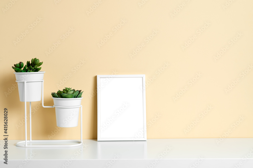 Flowers on a table or shelf, on a beautiful beige background. Place for text. Flowers on a table or shelf, on a beautiful beige background. Place for text.