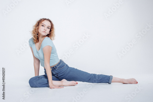 Attractive fit young girl the doing warm up stretching before training. The healthy lifestyle concept. Woman doing stretching yoga at home. Self-isolation is beneficial, entertainment and education
