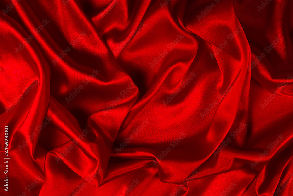 Obraz premium Red silk or satin luxury fabric texture can use as abstract background. Top view.