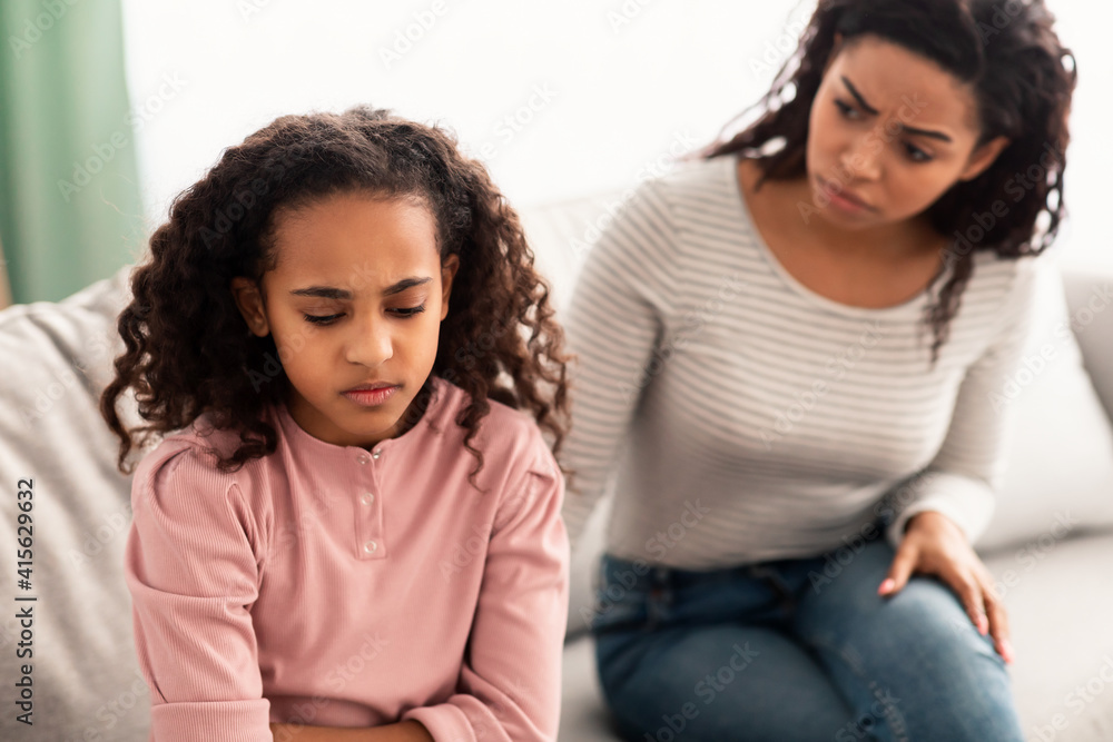 Family Conflict. Sad black daughter and mother after quarrel - obrazy, fototapety, plakaty 