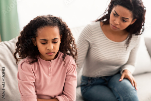 Konstfotografi Family Conflict. Sad black daughter and mother after quarrel