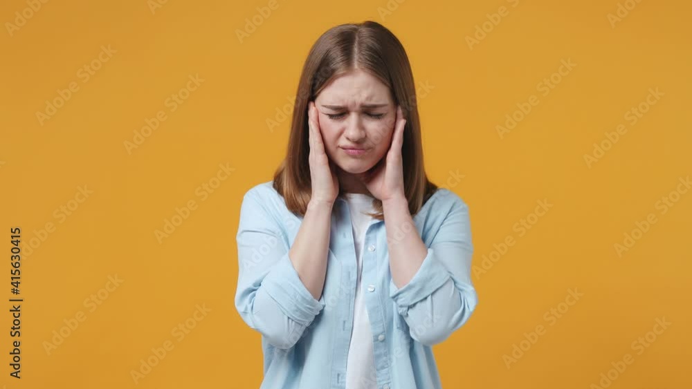 Tired upset blonde young woman 20s in blue shirt isolated on yellow background in studio. People lifestyle concept. Did not get enough sleep last night after party barely got up in the morning yawning Tired upset blonde young woman 20s in blue shirt isolated on yellow background in studio. People lifestyle concept. Did not get enough sleep last night after party barely got up in the morning yawning