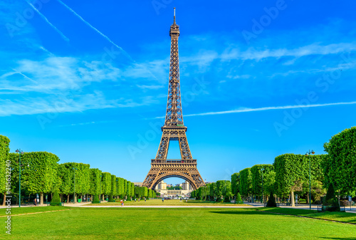 Paris Eiffel Tower and Champ de Mars in Paris, France. Eiffel Tower is one of the most iconic landmarks in Paris. The Champ de Mars is a large public park in Paris © Ekaterina Belova