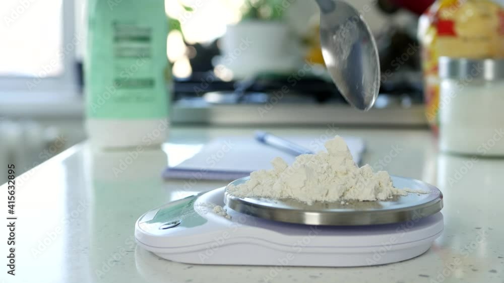 Chef in the Kitchen Weighs a Quantity of White Flour Using an Electronic Scale Chef in the Kitchen Weighs a Quantity of White Flour Using an Electronic Scale