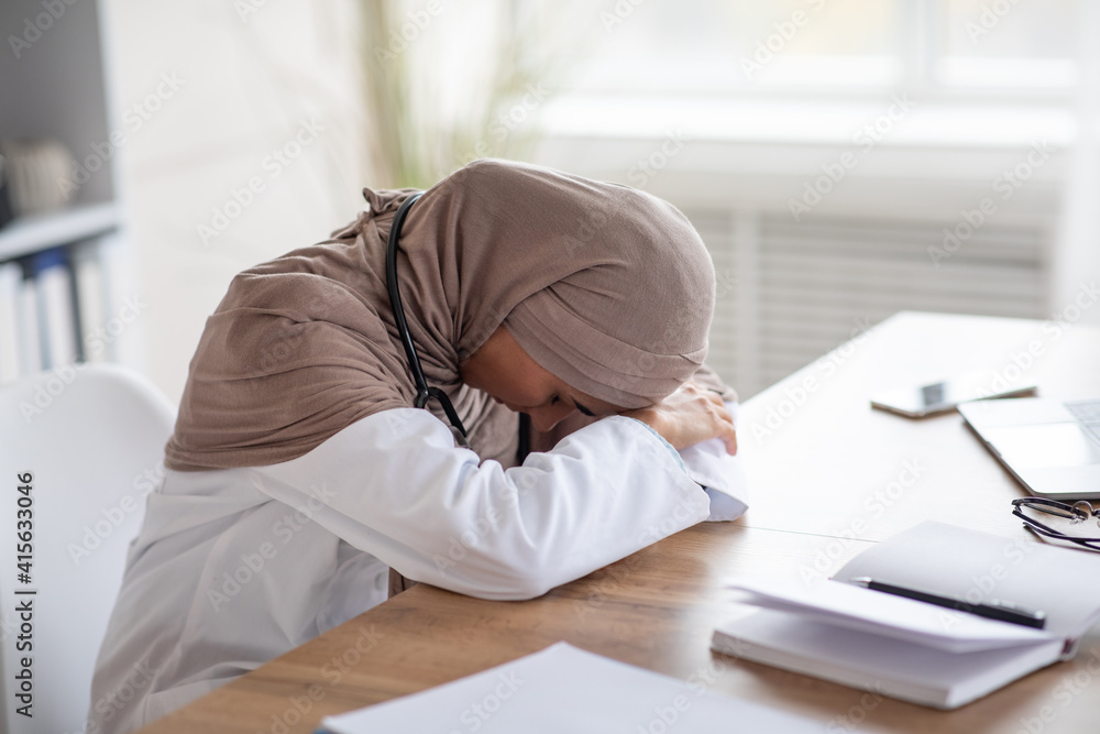Tired woman doctor having nap at workdesk Tired woman doctor having nap at workdesk