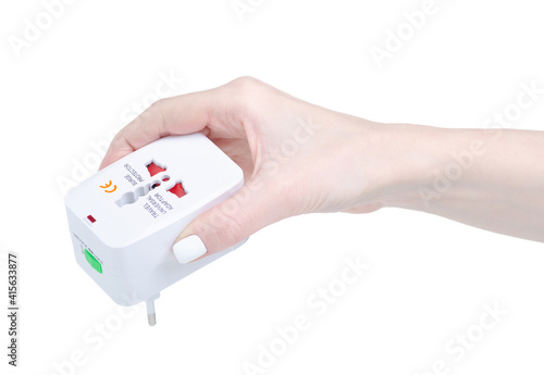 Travel universal adapter in hand on white background isolation