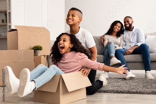 Photography Happy African American family celebrating moving day in new apartment