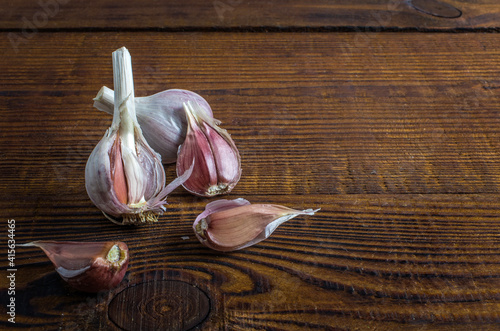 heads of garlic on a wood board. Rustic style photo