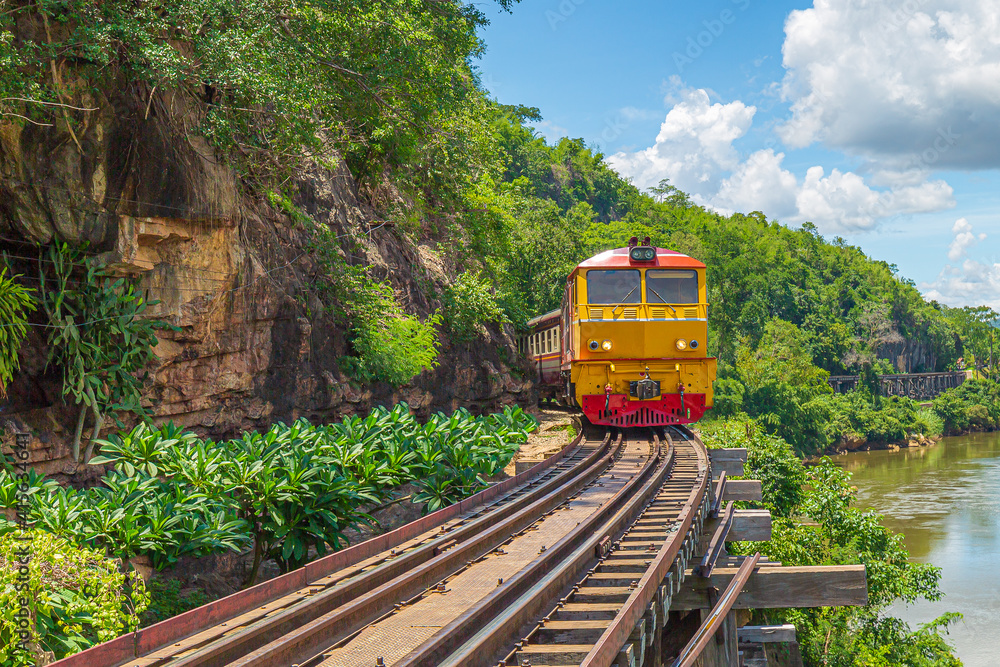 trains running on death railways track crossing kwai river in kanchanaburi thailand this