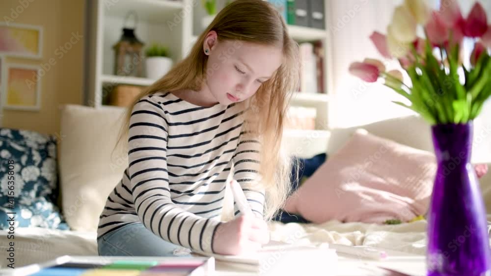Cute young girl writing letter at home. Child doing her homework in her room. Education for kids. Cute young girl writing letter at home. Child doing her homework in her room. Education for kids.