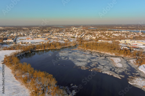Aerial view of a winter in suburb city with snow covered of Burlington, NJ residential quarters by the Delaware river