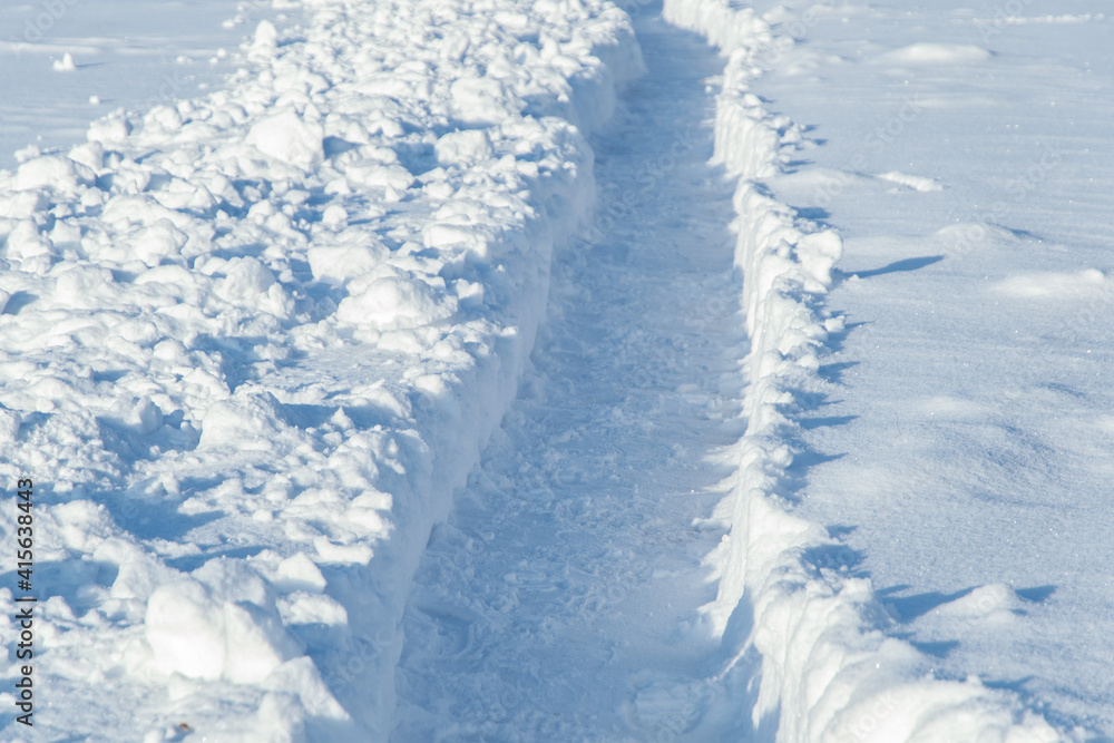 winter emergency: deep trench-trail in the snow, dug for the passage of people after heavy snowfall winter emergency: deep trench-trail in the snow, dug for the passage of people after heavy snowfall