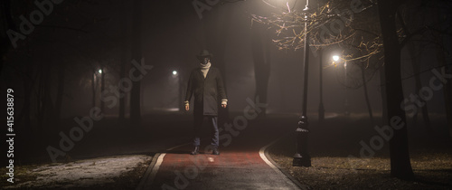 strange man on the road in the forest at night in the fog © serikbaib