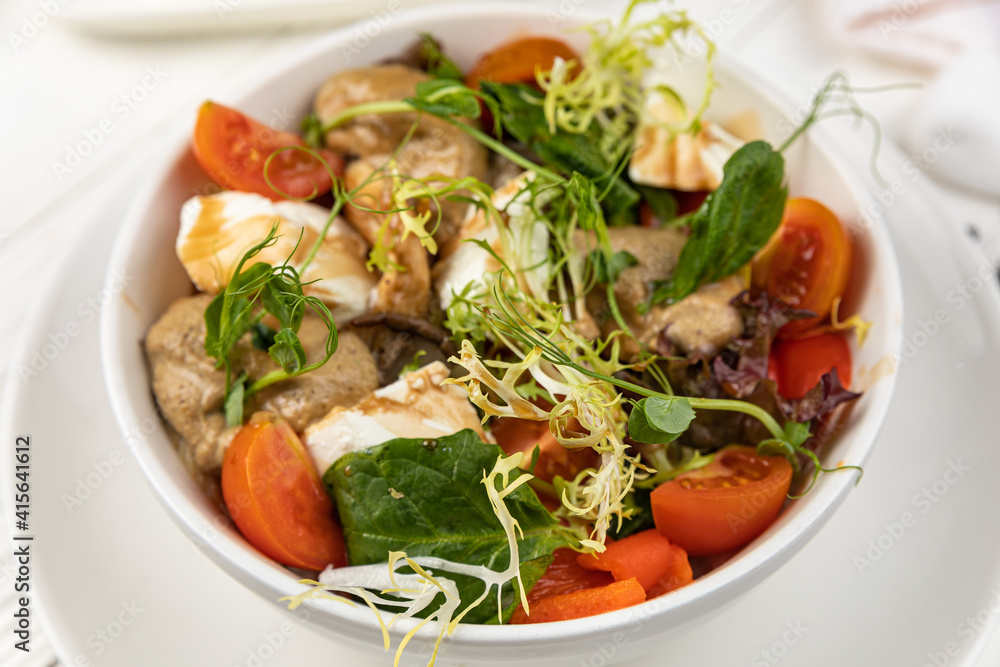 Cheese salad on a white wooden table
