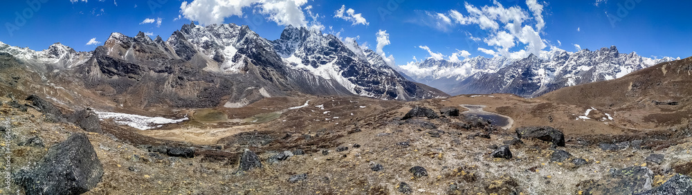 Panoramic view of Kyajo Ri mountain peak (6151 meters) in Himalayas in Nepal near Lunden village and Renjo La Pass. White clouds begin to gather over the mountain valley. Everest base track route.