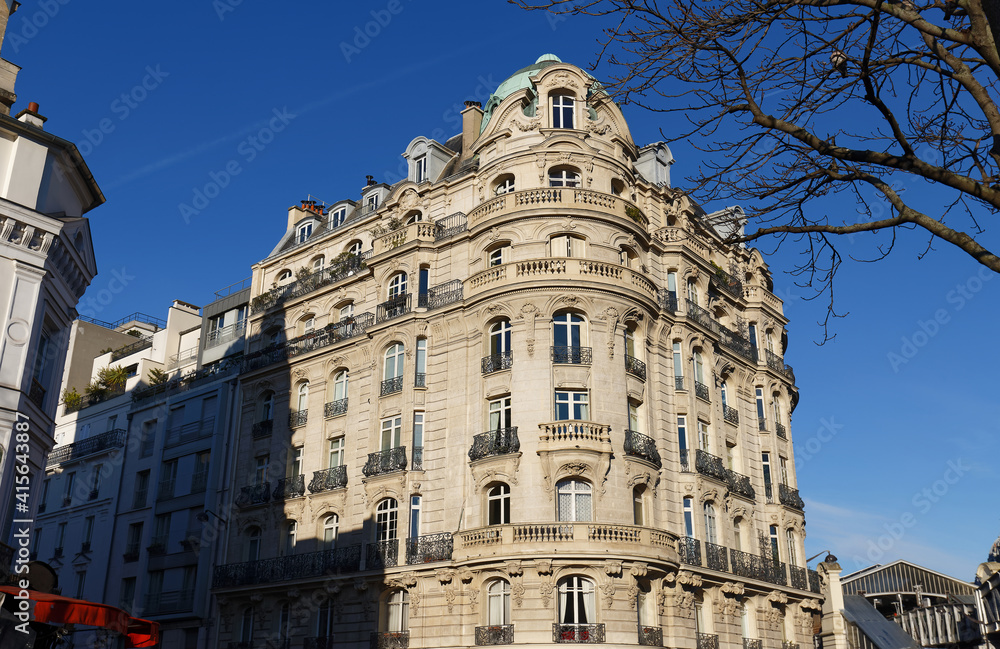 Traditional French house with typical balconies and windows. Paris .