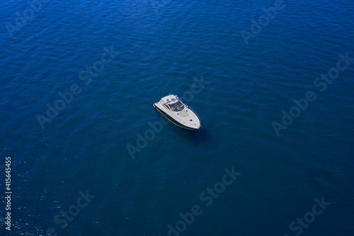 Yacht on blue water. Top view of the boat. Aerial view luxury motor boat. © Berg