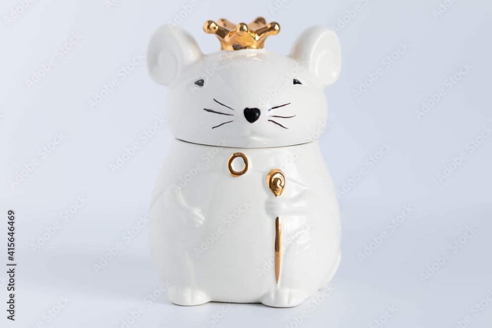 Fototapeta premium White porcelain rat princess in a golden crown.