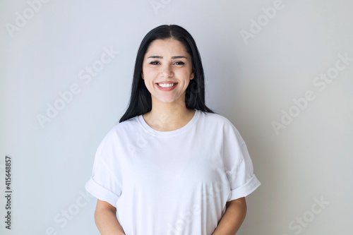 portrait of young happy woman looks in camera