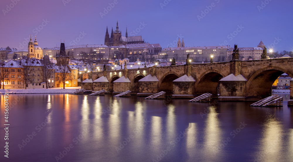 charles bridge and prague castle / winter morning with snow