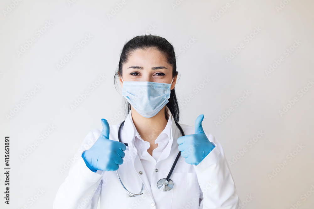 Covid19, coronavirus, healthcare and doctors concept. Portrait of optimistic female doctor assure everything be okay, thumb-up, wear medical mask to prevent catching virus, white coat