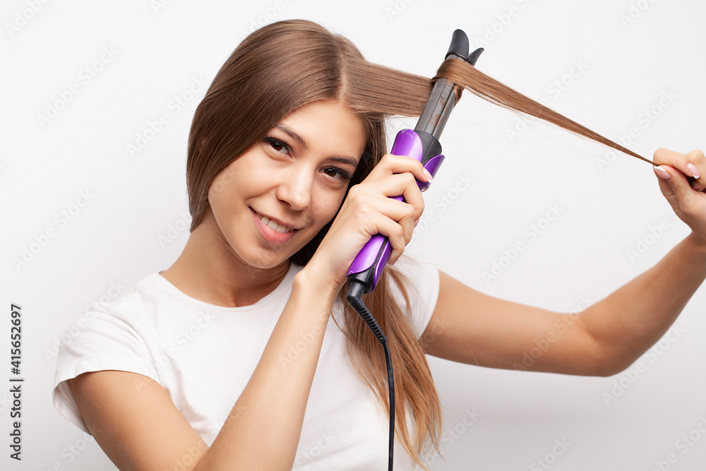 Woman With Beautiful Long Straight Hair Using Hair Straightener. Woman With Beautiful Long Straight Hair Using Hair Straightener.
