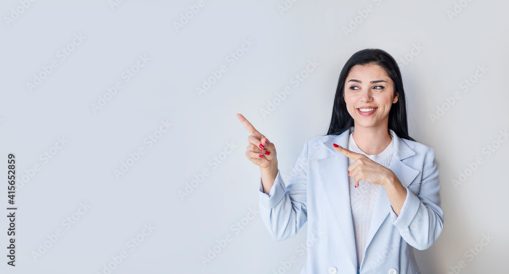 young woman pointing at your product and looks at it. young woman pointing at your product and looks at it.